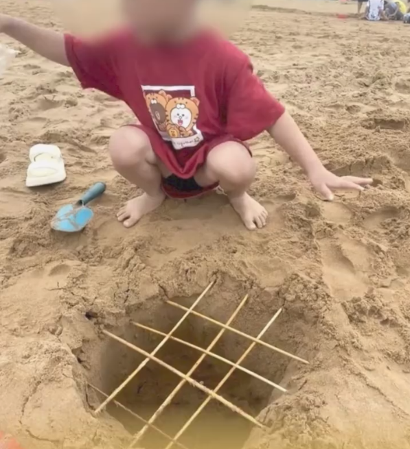母亲晒孩子在沙滩制竹签陷阱引争议：网友怒斥不正常
